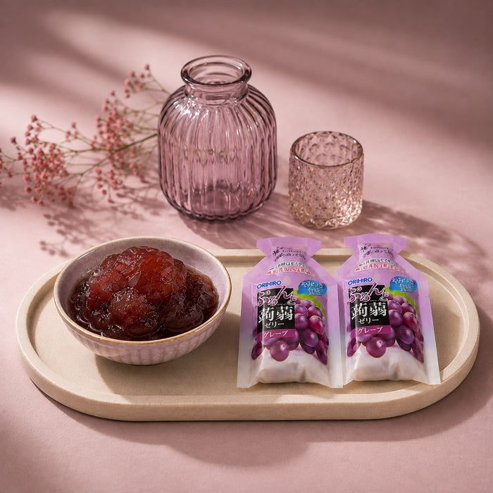 Grape konnyaku jelly squeezed from its pouch, a springy purple jelly.