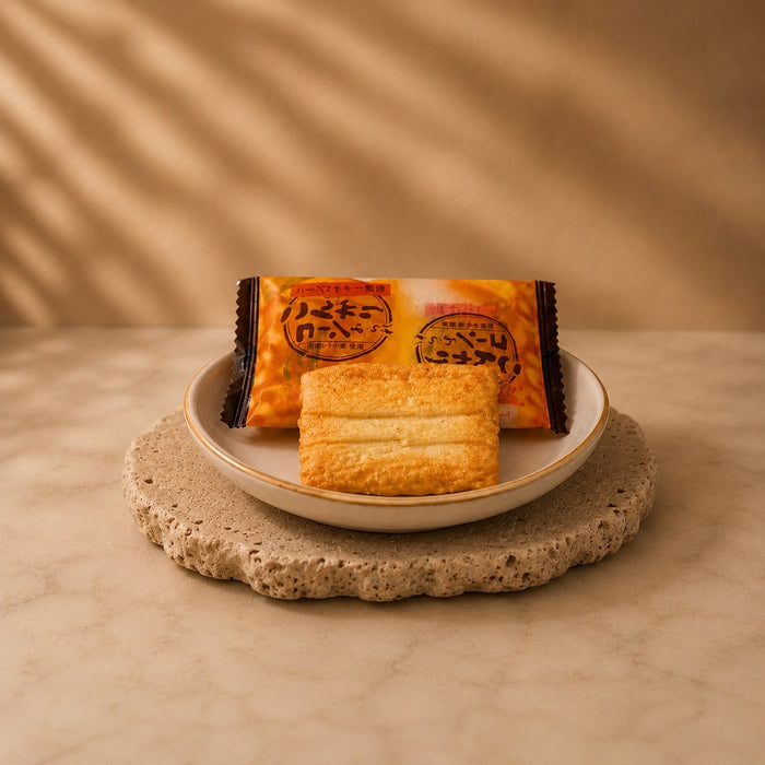 Teriyaki corn rice crackers out of the packet, small glazed golden-brown rice bites.