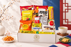 Open Snackstalgia box displaying Korean snacks and drinks, including Pepero, Kancho and Crispy Roll.